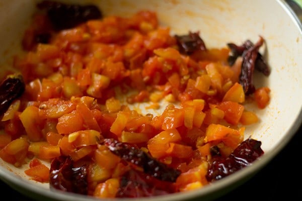 sautéing tomatoes on low heat. 