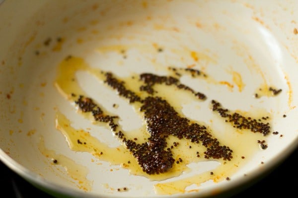 mustard seeds crackling in hot oil for tempering.