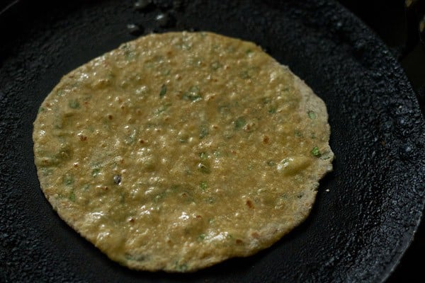 apply oil on mix veg paratha on a tawa