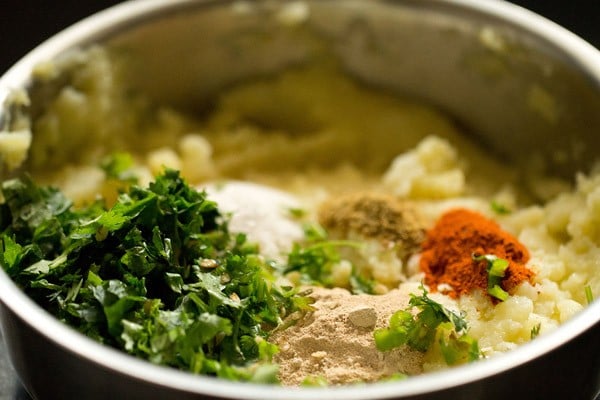 adding spices and herbs to mashed potatoes