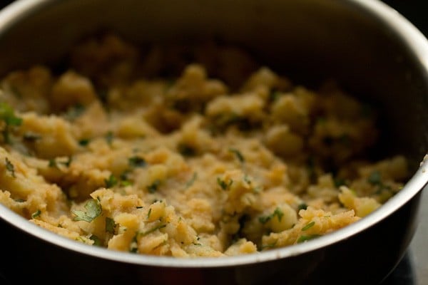 mixing spices and herbs in mashed potatoes 