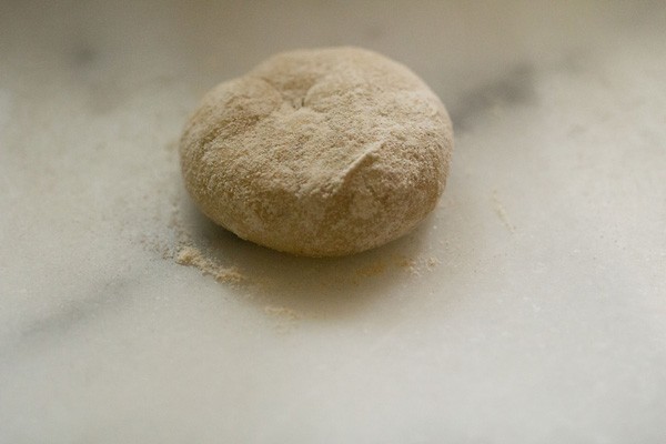 some whole wheat flour on dough ball before rolling