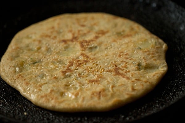 frying aloo kulcha till browned 