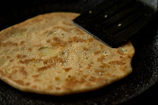 press edges for even cooking of kulcha