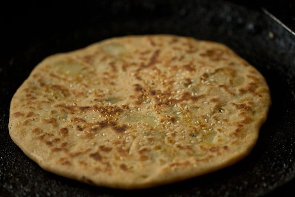 flip and roast aloo kulcha for even cooking 