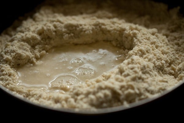 adding water to flour mixture 