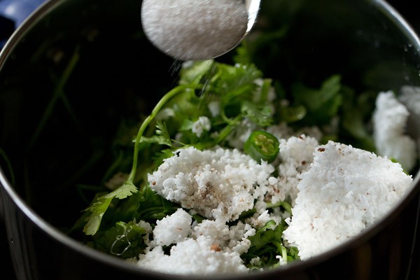 adding sugar and salt to the grinder jar. 