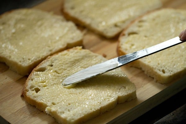spreading butter on bread slices. 