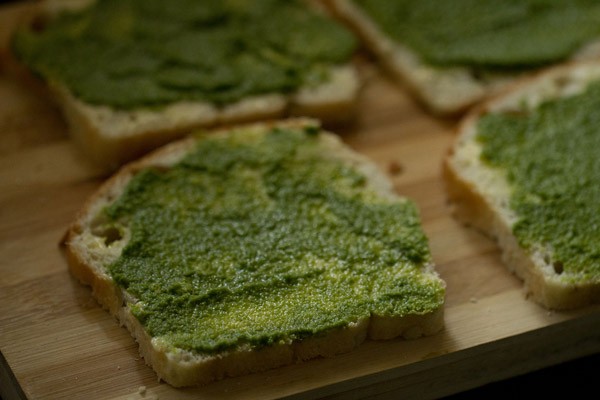 prepared chutney spread on buttered bread slices. 