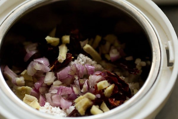 grated fresh coconut, chopped shallots, dried red chilies and chopped ginger added in a grinder jar. 