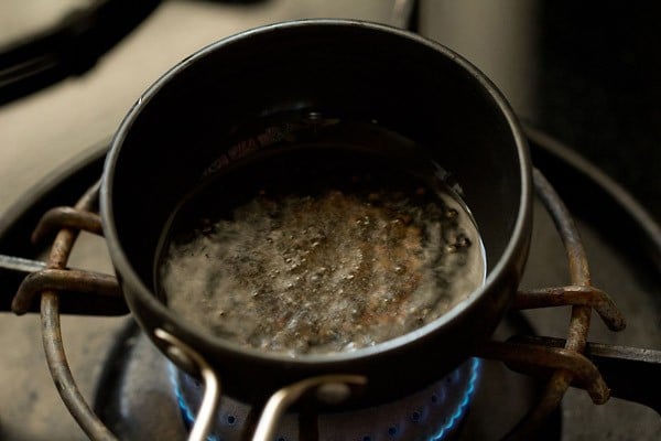frying urad dal in hot coconut oil. 