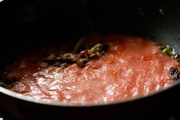 prepared tomato puree added in the pan. 