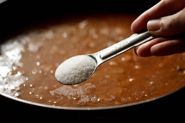 adding salt to the pan. 