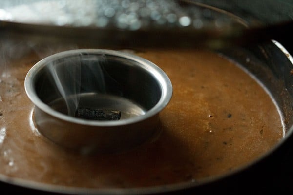 the steel bowl with the smoking charcoal kept on top of the dal makhani in the pan. 