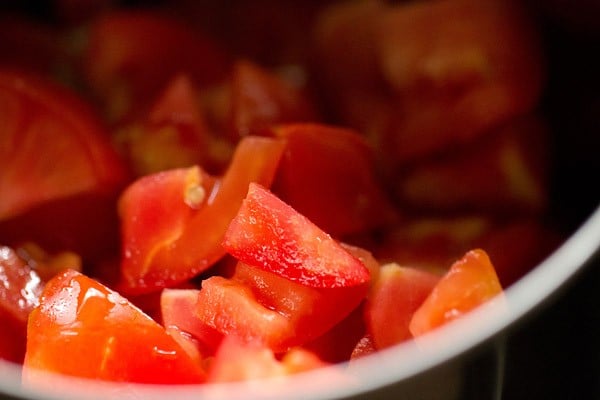 chopped tomatoes added in a blender jar for dal makhani recipe. 
