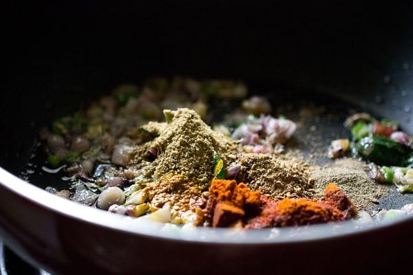 ground spices added to pan with aromatics for kadala curry recipe