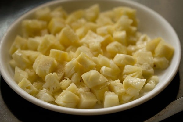 chopped pineapple cubes on a plate. 