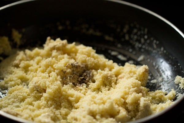 cardamom powder added to the rava in pan. 