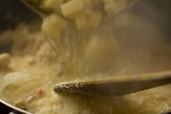 pouring pineapple-water mixture to the roasted rava. 