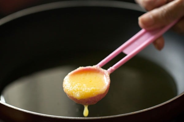 adding ghee to hot pan. 