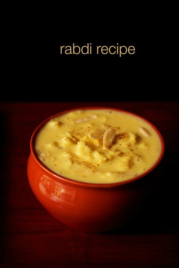 rabdi in red bowl with nuts and a light sprinkle of saffron powder from top