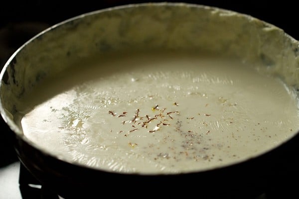 saffron and cardamom on thickened milk to make rabri recipe
