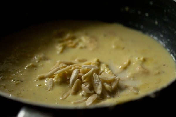 mound of slivered nuts on rabdi in pan