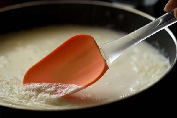 clotted cream layer being moved with orange spatula