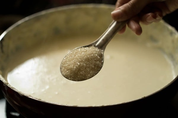 sugar being added in a tablespoon 
