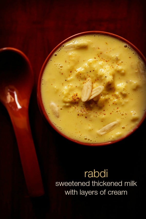 top shot of rabdi in red bowl with nuts and a light sprinkle of saffron powder from top with text layovers