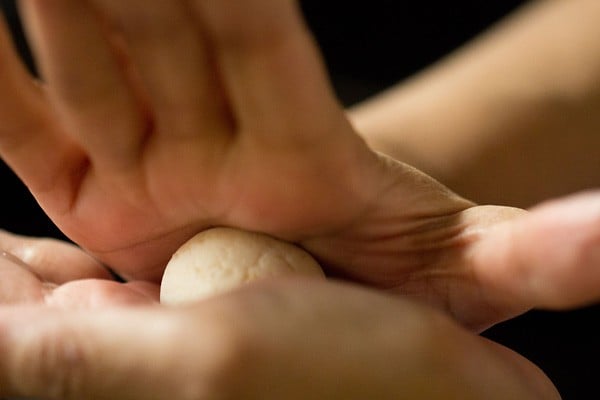 hands rolling out an individual rasgulla