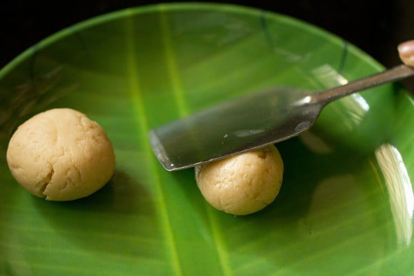 pressing rasgulla with the flat side of a spatula for rasmalai recipe