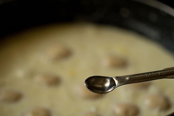 adding kewra water to rasmalai pan