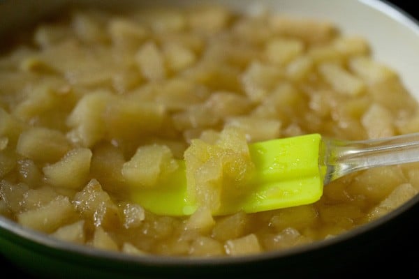 apples are ready to be mashed into applesauce when they are grainy looking and easy to smash with a spatula.