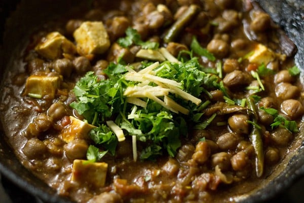 garnish chole paneer gravy with ginger julienne and coriander leaves