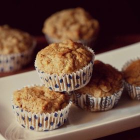 banana muffin placed on top of two banana muffins in a white tray