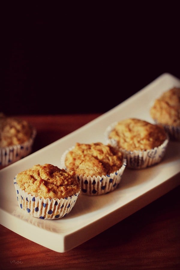 four baked banana muffins in a row on plate