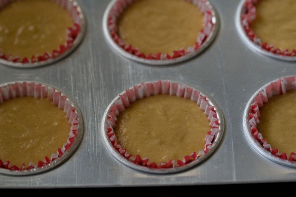 eggless orange muffins batter in muffins liner