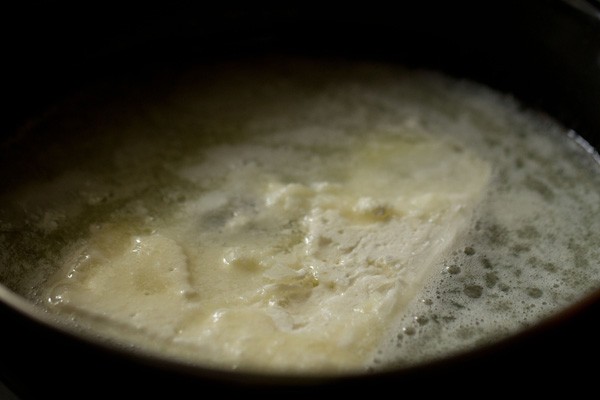 butter being melted in black pan