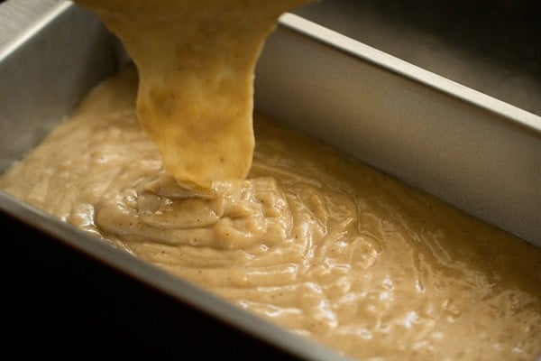 pouring eggless pound cake batter in loaf pan