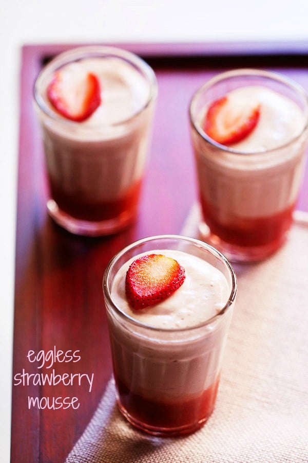 strawberry mousse garnished with fresh strawberry slices and served in three shot glasses with text layover.