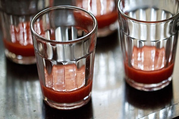 strawberry puree added to shot glasses. 