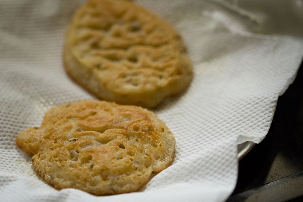 draining fried malpua on paper towels