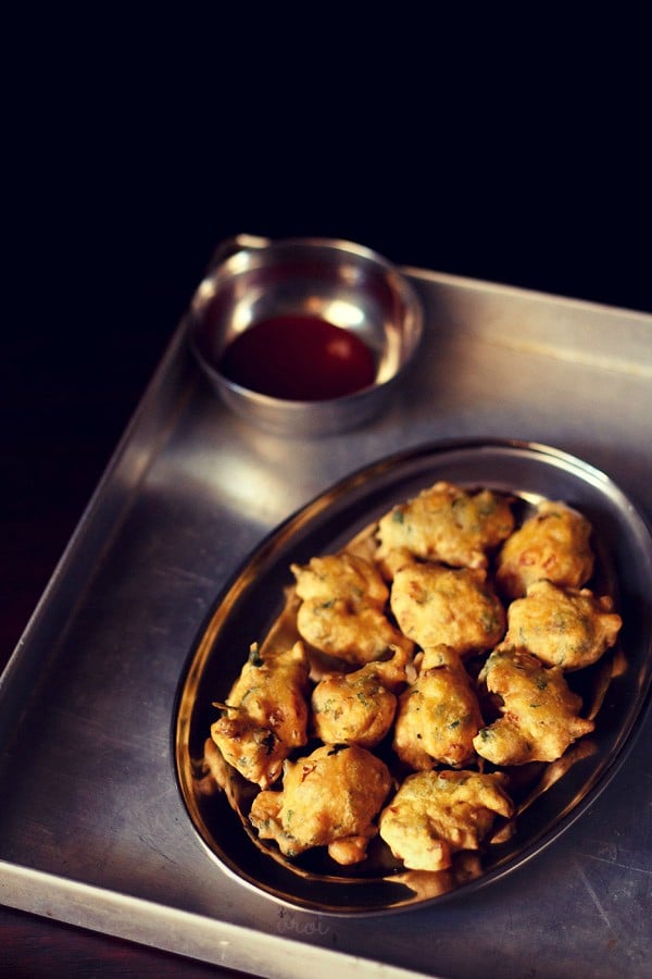 methi pakora served on a plate with a side of chutney