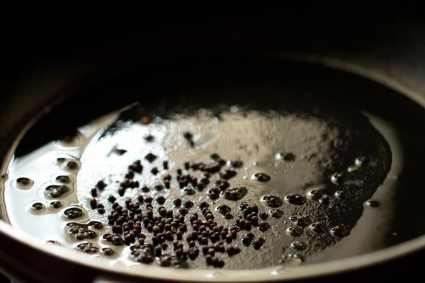 hot oil in a skillet with mustard seeds