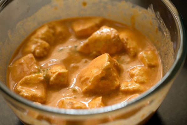 marinating cheese cubes to make the paneer 65 recipe.