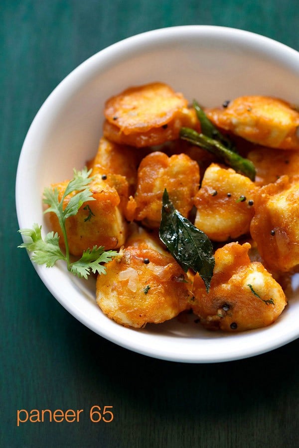 paneer 65 with a coriander sprig at right side in a white bowl.