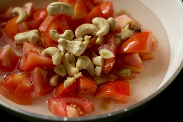 chopped tomatoes, spices and cashews and water in a pan