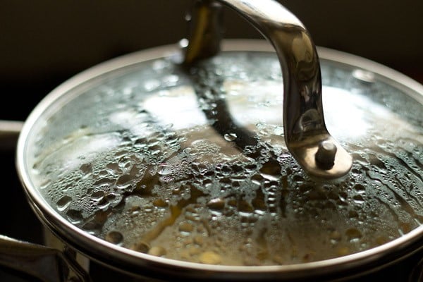 cooking kara kuzhambu in covered pan. 