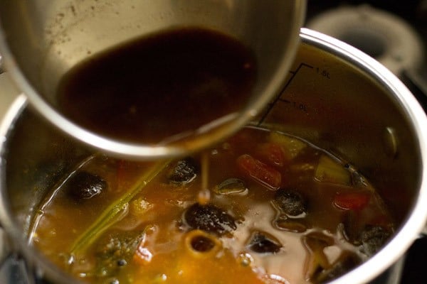 adding tamarind extract to kara kuzhambu. 